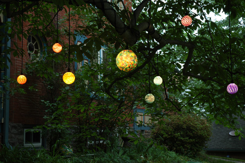 decorative garden balls hanging in tree