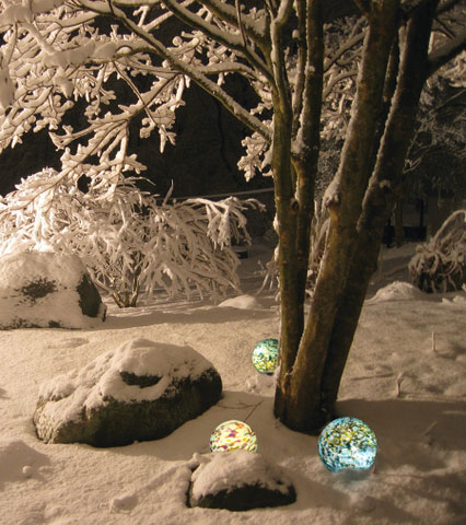 Three 8” Earth color pattern Nightorbs night lighting in snow