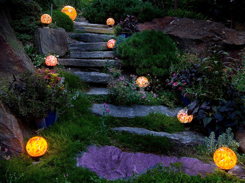 Nightorbs Hand blown glass globes landscape lighting on garden granite steps