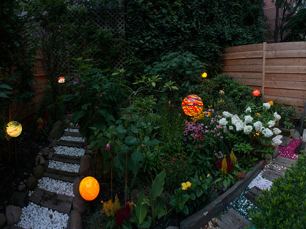 New York city garden with multiple colored Nightorbs creating spheres of light