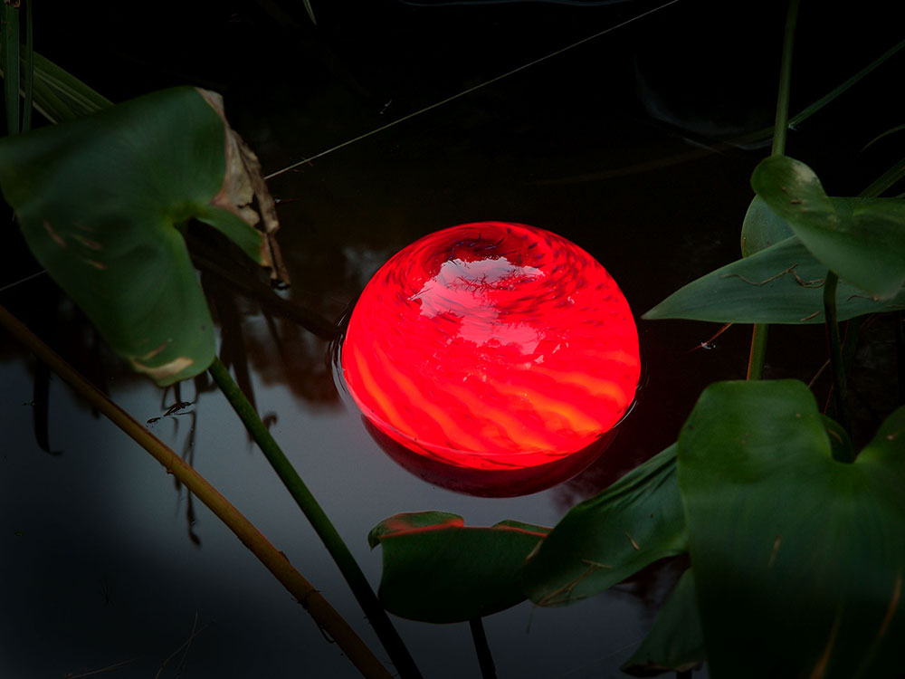 One Red 8 inch waterorb providing water feature lighting