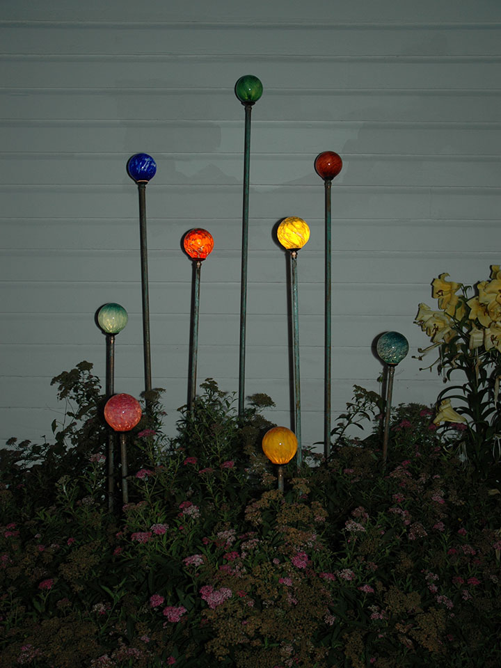 Nine copper stem Orblets crowning shrub lighting